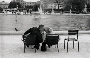 Kissing couple in a park, Paris, France Kissing couple in a park, Paris, France