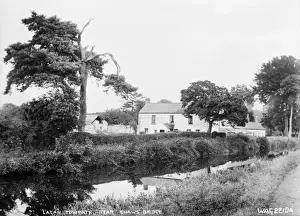 Prints of Lagan Towpath near Shaws Bridge - a view of the towpath and the river beside, there are buildings to the rear, on the far bank of the river. (Location: Northern Ireland: County Antrim: Belfast) River Prints: Early 20th Century Lagan Towpath Print