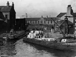 Prints of Barges loaded with bales of raw cotton, destined for the cotton mills, Leeds - Liverpool Canal, Blackburn, Lancashire, England. Date: 1930s United Kingdom Prints: Lancashire Cotton Barge Print, 1930s