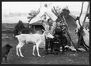 Prints of A Lapland man and woman with their two children, reindeer and dog, outside their tepee Reindeer Prints: Lapland Family Print