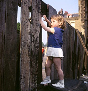 Little girl climbing on a fence, Balham, SW London Little girl climbing on a fence, Balham, SW London
