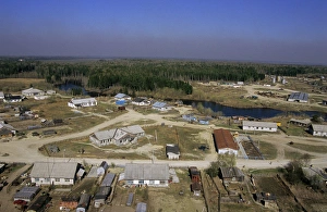 Maloyuganskii village - aerial of village and taiga forest Maloyuganskii village - aerial of village and taiga forest