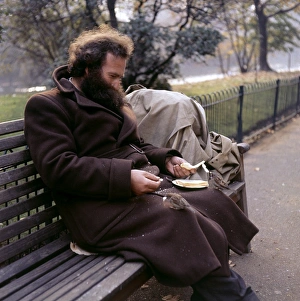 Man feeding sparrow in a Balham park, SW London Man feeding sparrow in a Balham park, SW London