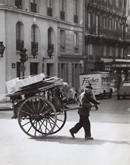 Man pulling a loaded cart, Paris, France Man pulling a loaded cart, Paris, France