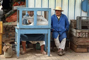 Man sits beside a small food stall in Houmt Souk, Djerba Man sits beside a small food stall in Houmt Souk, Djerba
