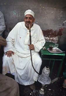 A man sits in a back street tea shop in Cairo, Egypt A man sits in a back street tea shop in Cairo, Egypt