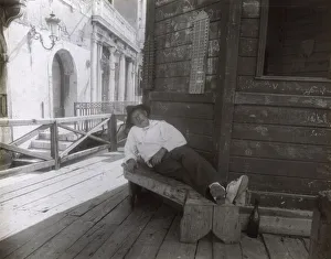 Man sleeping on a bench in a side street, Venice, Italy Man sleeping on a bench in a side street, Venice, Italy