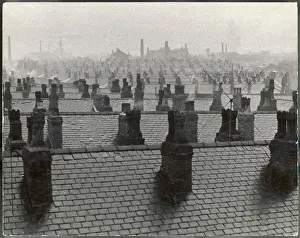Prints of Manchester skyline - an urban cityscape of rooftops and chimney stacks, the air grey with industrial smog Aerial View Prints: Industrial Manchester Rooftops Print