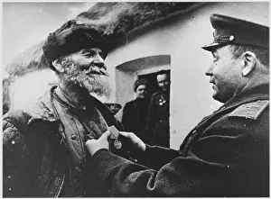 Prints of A splendidly bearded senior resistance fighter receives a medal for his heroic activities Resistance Movement Prints: Medal for Partisan Print