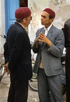 Two men talk in the street in Houmt Souk, Djerba, Tunisia Two men talk in the street in Houmt Souk, Djerba, Tunisia