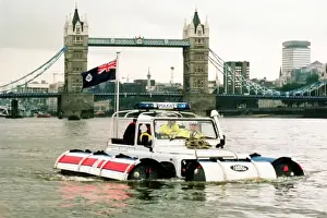 Prints of A Metropolitan Police launch on the River Thames, with Tower Bridge in the background Police Prints: Metropolitan Police Launch on the River Thames Print