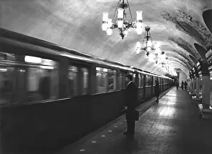 Prints of A business man commuter, about to board an underground train, which has just arrived on the platform of a Rococo style tube station, Moscow, Russia. Date: late 1960s Rococo Architecture Prints: Moscow Underground A Business Man Commuter Print, Late 1960s