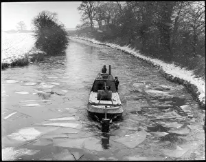 Prints of An icebreaker narrow boat on the frozen Grand Union Canal, near Buckby Wharf, Northamptonshire, England Northamptonshire Prints: Grand Union Canal Icebreaker Narrow Boat Print