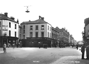 Prints of Newry - view from Margaret square to Hill St, a busy street scene with shop fronts and people, horse vehicles and motor car. (Location: Northern Ireland; County Down; Newry). Date: circa early 1900s County Armagh Prints: Early 20th Century Newry Street Scene Print