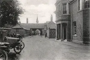 Prints of Rear view of the entrance to the No. 1 War Hospital, Reading, Berkshire - the First World War deployment of Reading Union Workhouse. Several uniformed soldiers can be seen, one on crutches Berkshire Prints: Rear View of No. 1 War Hospital, Reading Print