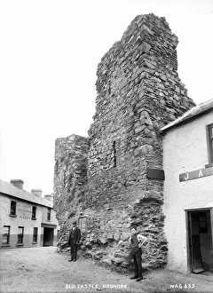 Prints of Old Castle, Dromore - a view of the derelict castle set in the town with man and boy outside for scale. (Location: Northern Ireland: County Down: Dromore). Date: circa early 1900s Castle Prints: Early 20th Century Print of Dromore Old Castle