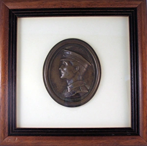 Oval plaque in relief depicting the head of a young Tommy Oval plaque in relief depicting the head of a young Tommy