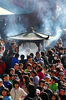 People burning incense at Senso Ji Temple in Asakusa, Tokyo People burning incense at Senso Ji Temple in Asakusa, Tokyo