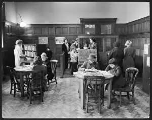 Prints of An orderly scene at Putney Junior Library, where Story Hour is held every alternative Thursday at 4.45 precisely. Smartly-dressed, well-behaved children frequent the library Putney Prints: Putney Junior Library Print: A Well-Behaved Afternoon Scene