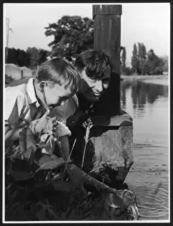 A Child Returns Fish to the River Print