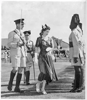 Prints of ELIZABETH II inspecting the guard of honour mounted by the Uganda police during the Queens short visit. They are wearing khaki drill and dark blue tarbooshes Drill Prints: Elizabeth II Inspecting Guard of Honour in Uganda Print