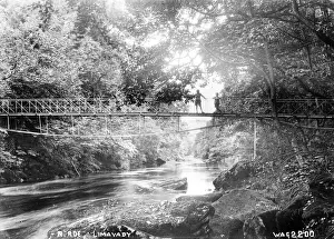 Prints of R. Roe, Limavady - a view of two boys standing on a suspension bridge over the river. (Location: Northern Ireland; County Londonderry; Limavady). Date: circa early 1900s County Londonderry Prints: Limavady Suspension Bridge Print, Northern Ireland