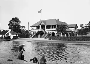 Prints of River Lagan at the Boathouse, Belfast - view across the Lagan, with boys in the foreground fishing. (Location: Northern Ireland: County Antrim: Belfast). Date: circa early 1900s River Prints: River Lagan at the Boathouse, Belfast Print