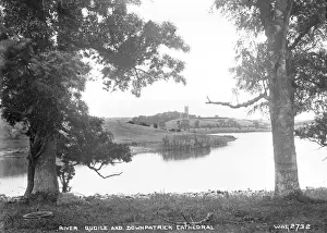 Prints of River Quoile and Downpatrick Cathedral - a view with trees and river in the foreground to the Cathedral in the distance. (Location: Northern Ireland; County Down; Downpatrick). Date: circa early 1900s River Prints: River Quoile and Downpatrick Cathedral Print, Northern Ireland