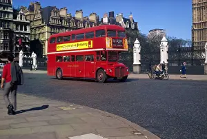 Prints of A No.76 Routemaster bus drives past the Houses of Parliament, Westminster, on its way to Stoke Newington, north London Borough Prints: Routemaster Bus Print: Westminster Scene