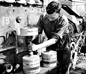 Royal Engineer adjusting a Flying Dustbin charge; Second W Royal Engineer adjusting a Flying Dustbin charge; Second W