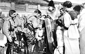 A Russian soldier kissing the cross before leaving for the front A Russian soldier kissing the cross before leaving for the front