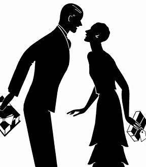 Silhouette of couple giving each other Christmas presents Silhouette of couple giving each other Christmas presents