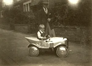 Small boy with chrome shiny silver pedal car Small boy with chrome shiny silver pedal car