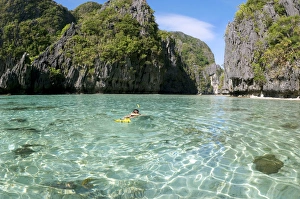 A snorkeller swims into an entry of a Big Lagoon A snorkeller swims into an entry of a Big Lagoon
