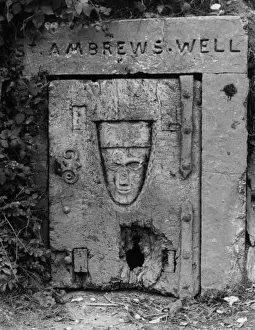 Prints of St. Ambrews Well, Crantock, near Newquay, Cornwall, England. This iron door with a carving of a mans face on it, covers the 10th century well, dedicated to St. Ambrew. Date: 10th century Well Prints: 10th Century St. Ambrews Well Print, Crantock, Cornwall