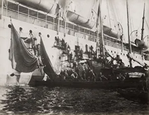 Supplies being loaded on a ship in harbour, Asia Supplies being loaded on a ship in harbour, Asia