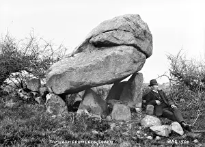 Prints of Tamlach Cromlech, Coagh - a Dolmen with a man sitting to the right. (Location: Northern Ireland: County Tyrone: Coagh). Date: circa early 1900s Map Prints: Tamlach Cromlech Print, Coagh, Northern Ireland
