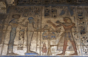 Temple of Ramses III. The pharaoh making offerings before go Temple of Ramses III. The pharaoh making offerings before go