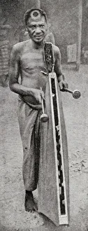 Tribesman playing tattoo, French Congo, Central Africa Tribesman playing tattoo, French Congo, Central Africa