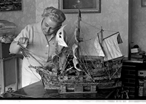 Woman with model ship made of matchsticks Woman with model ship made of matchsticks