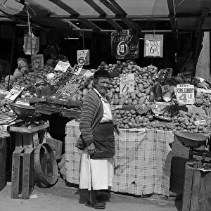 Woman and vegetable stall, East End of London Woman and vegetable stall, East End of London