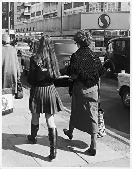 Prints of Two women walk down the Kings Road, Chelsea, London as traffic passes by Kensington And Chelsea Prints: Two Women on Kings Road Print