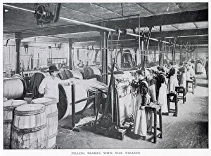 Women working in a large factory making wax candles with a foreman standing watching them Women working in a large factory making wax candles with a foreman standing watching them