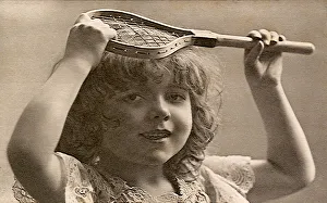 Young girl holding very little tennis racquet Date: 1905 Young girl holding very little tennis racquet Date: 1905