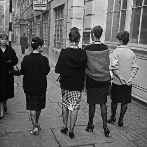 Four young women walking along a street, London Four young women walking along a street, London