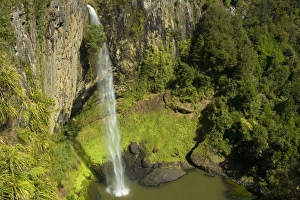 Bridal Veil Falls - water rushes in a thin jet down a steep ledge into a large pool surrounded by lush temperate Bridal Veil Falls - water rushes in a thin jet down a steep ledge into a large pool surrounded by lush temperate