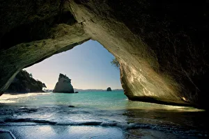 Cathedral Cove - by erosion artfully sculpted rock formation seen from the inside of a natural rock arch at Cathedral Cathedral Cove - by erosion artfully sculpted rock formation seen from the inside of a natural rock arch at Cathedral