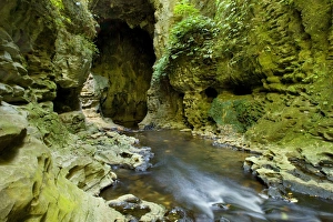 Limestone Tunnel - river flows through a deep and narrow gorge into a cave-like limestone Limestone Tunnel - river flows through a deep and narrow gorge into a cave-like limestone