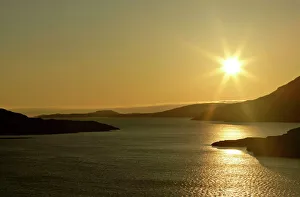 Sunset over Loch Broom - with sun still up casting red light over water Sunset over Loch Broom - with sun still up casting red light over water