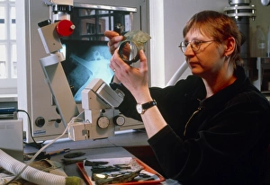 Archaeologist reconstructing fragmented Celtic pot Archaeologist reconstructing fragmented Celtic pot